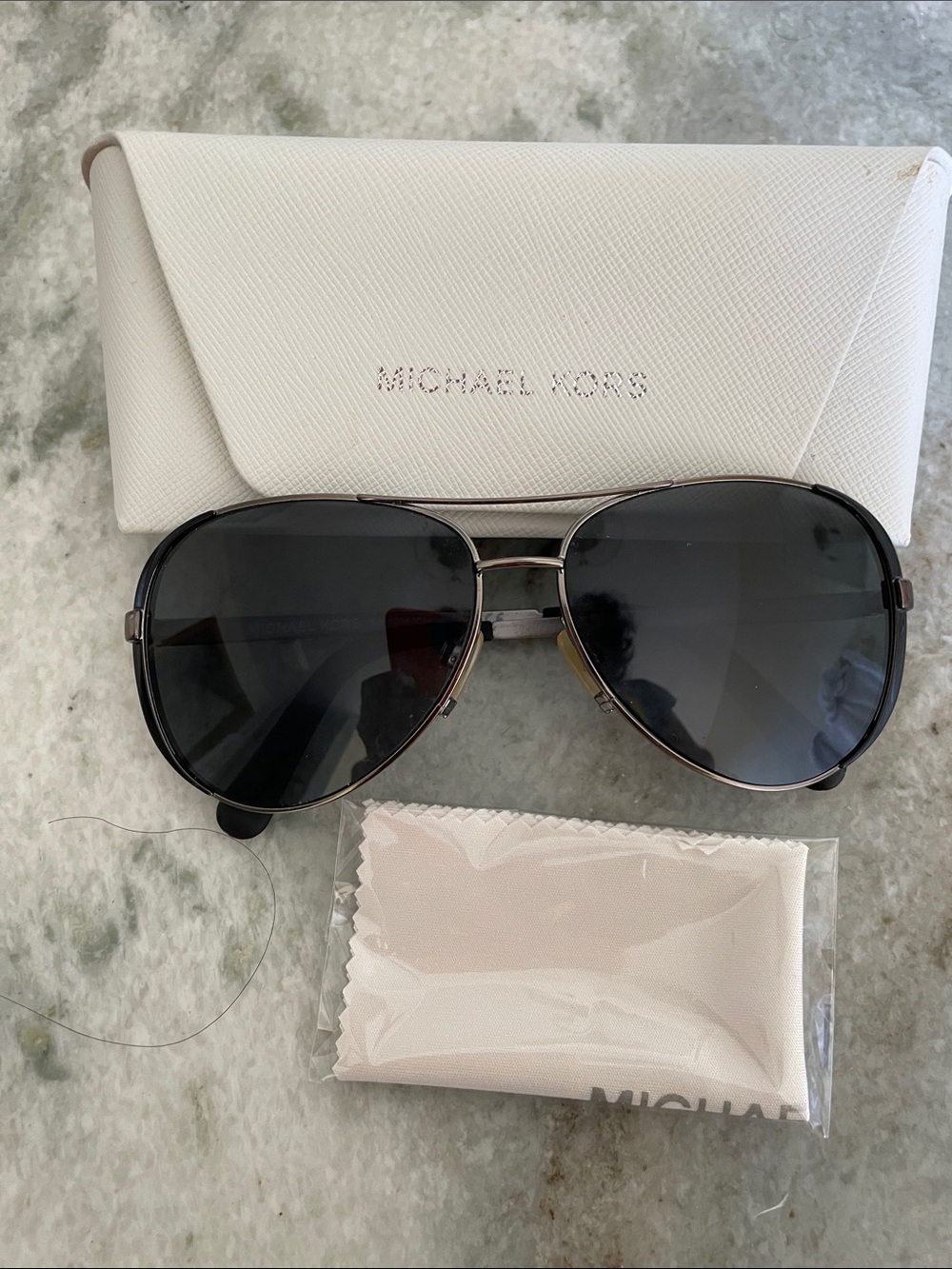 Michael Kors Gunmetal Aviator Sunglasses with Dark Gray Lenses.